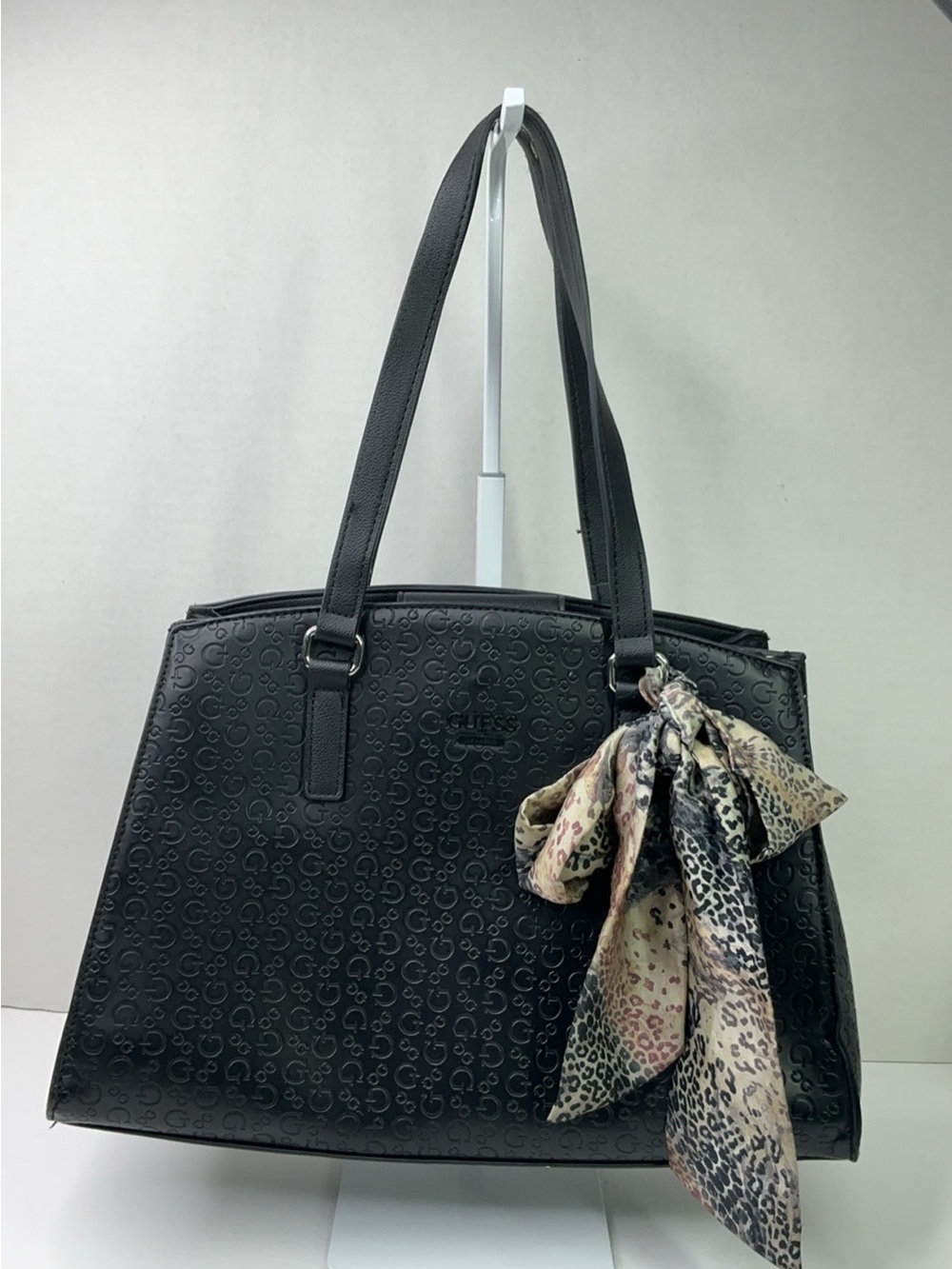 Guess Berlanti satchel features a black debossed monogram design.